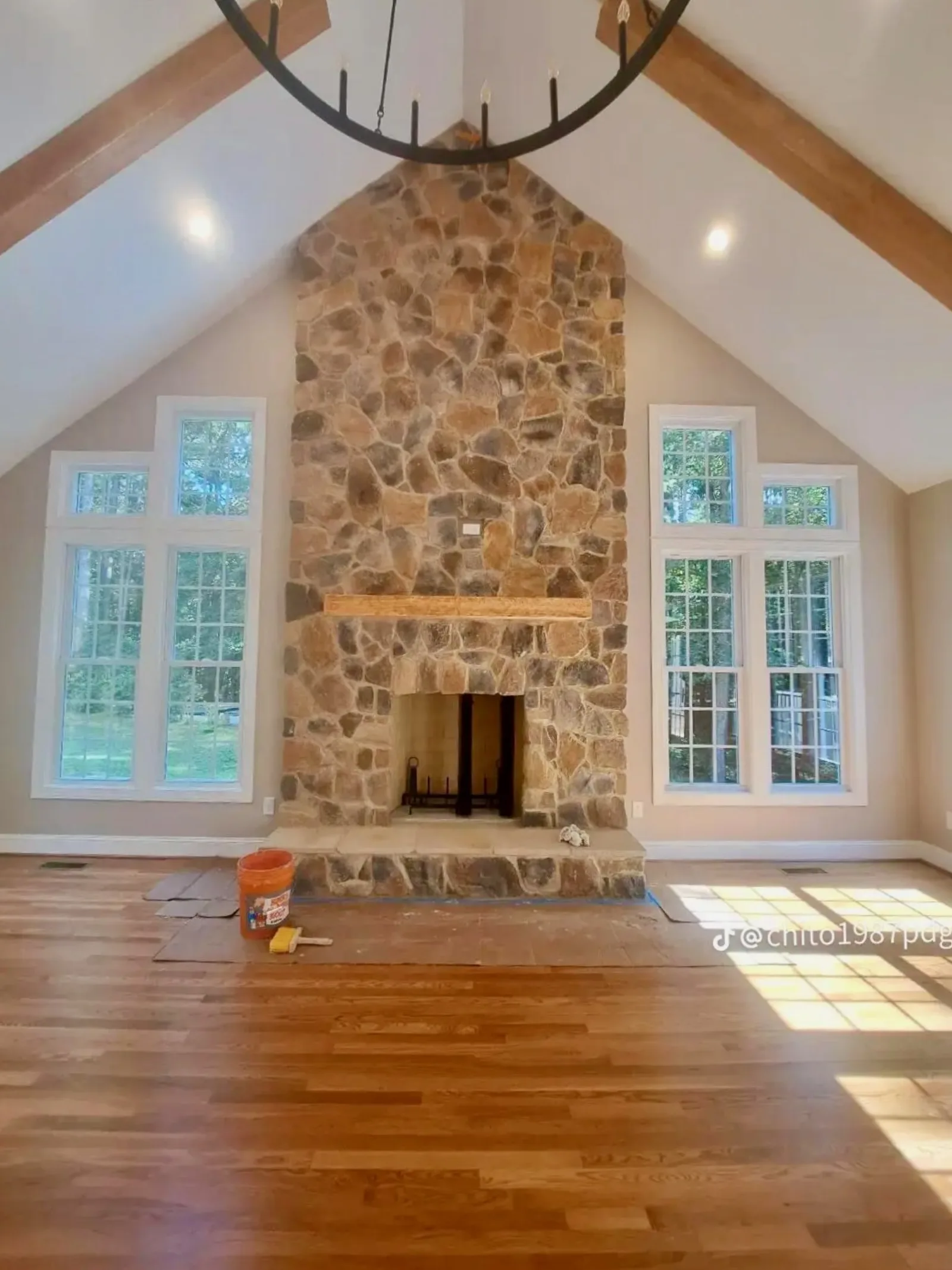 Floor-to-ceiling stone fireplace finished