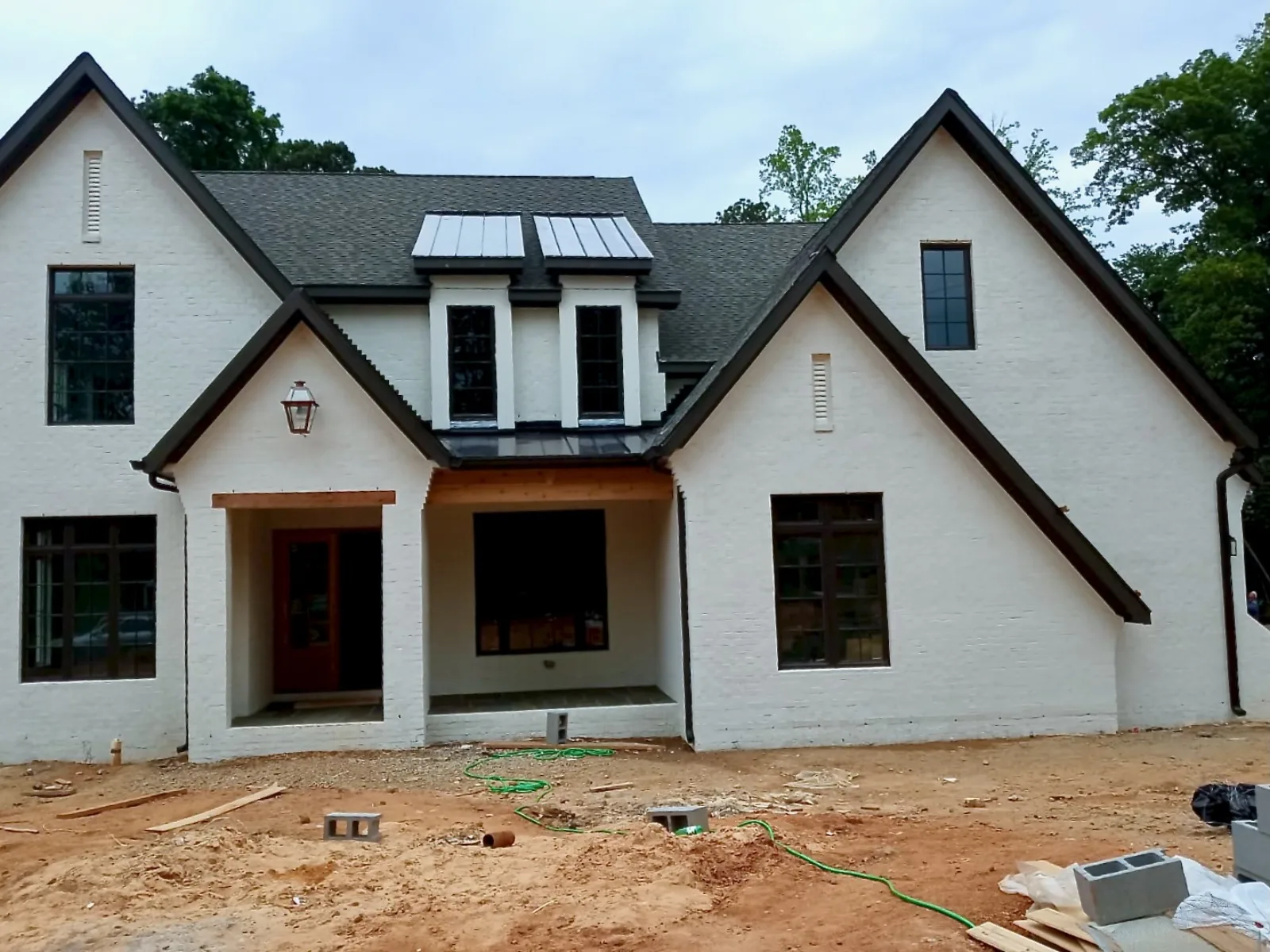 White brick exterior with finished siding details