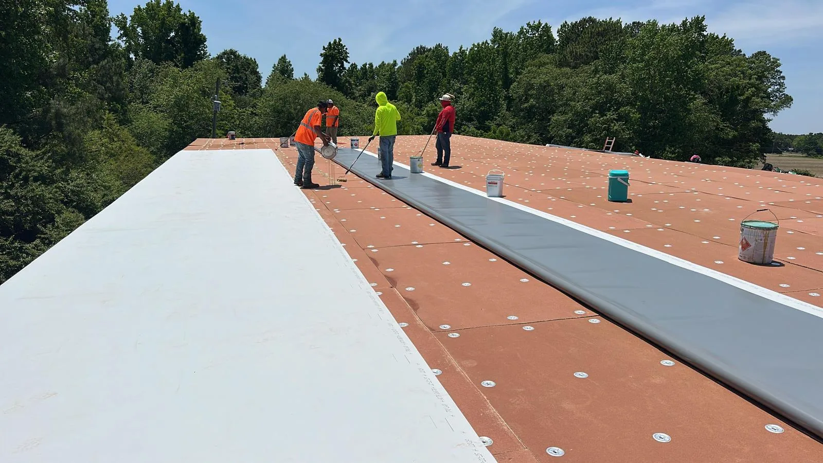 CG Construction LLC crew installing a TPO flat roof system